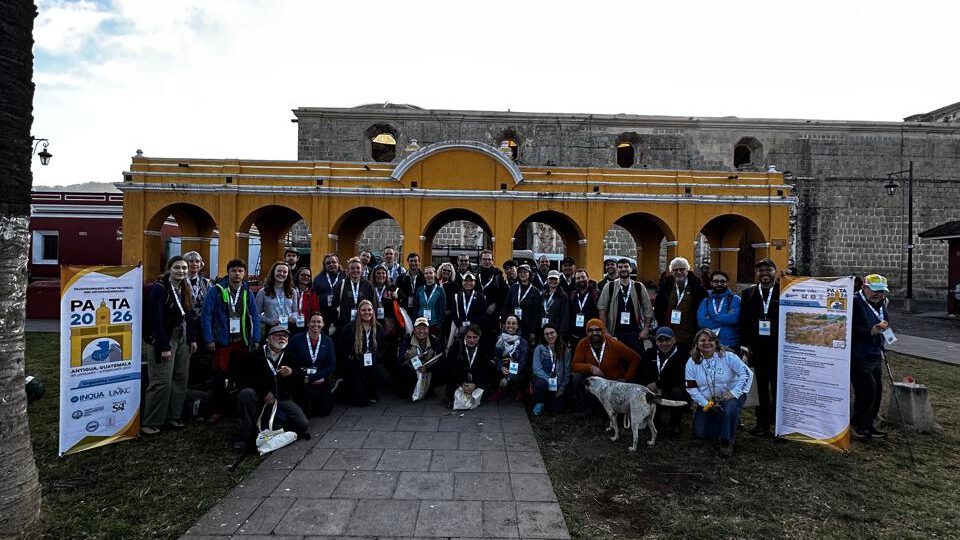 a group photo of scientists in front of an old building