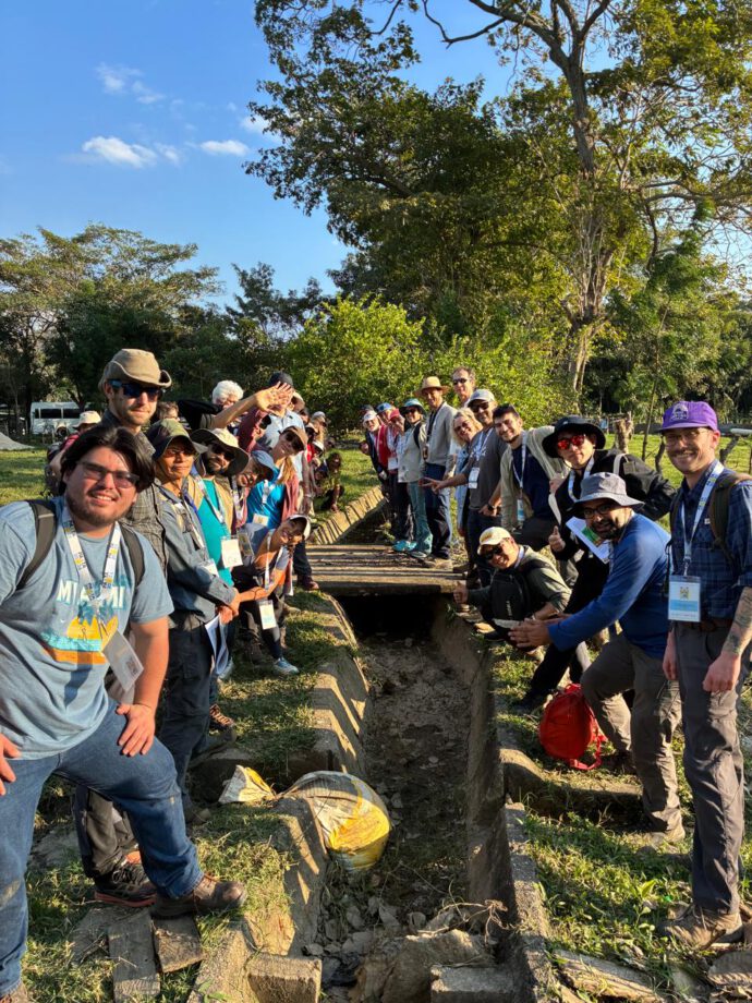 scientists along a canal that bends to the left